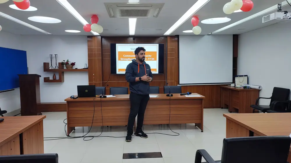 Mostafa presenting to a room of participants at a training workshop